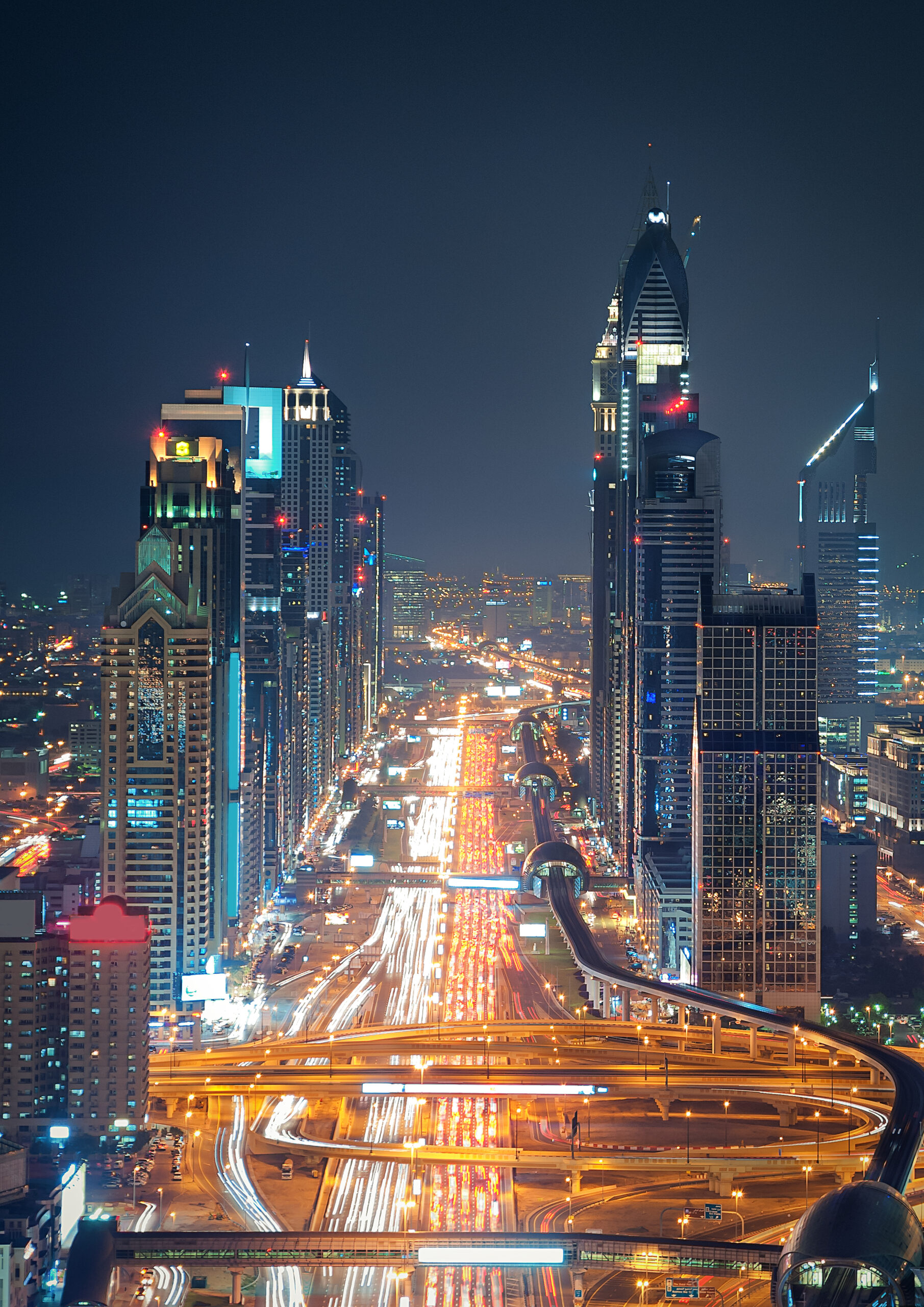 Amazing night dubai downtown skyline with tallest skyscrapers and road leading to Abu Dhabi during rush hour, Dubai, United Arab Emirates